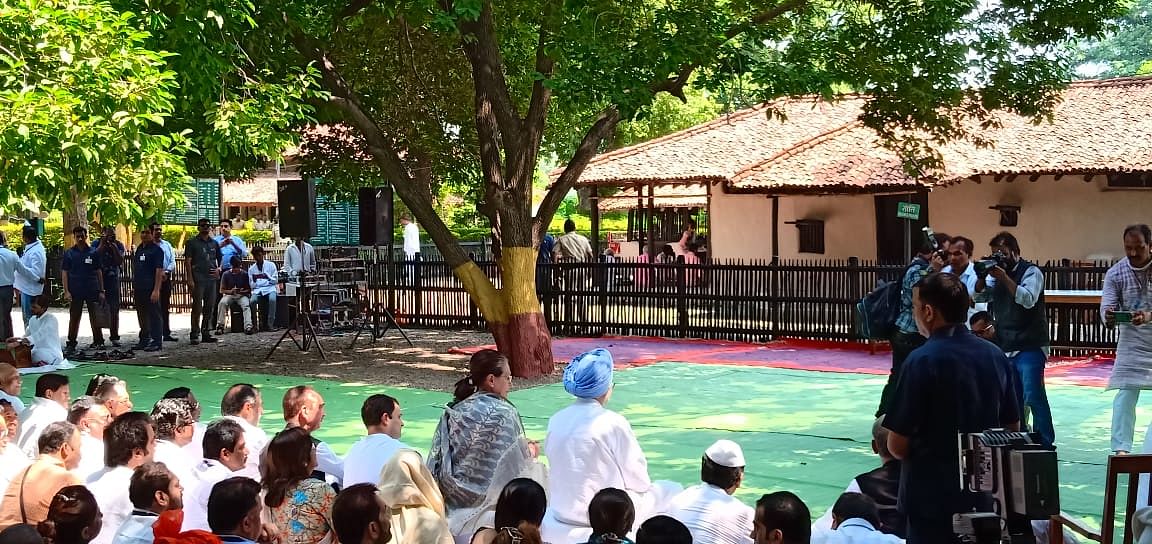 Congress president Rahul Gandhi, his mother Sonia and former prime minister Dr Manmohan Singh attend a prayer meeting outside Bapu Kuti at Sevagram in Wardha, Maharashtra. (DH Photo/Mrityunjay Bose)