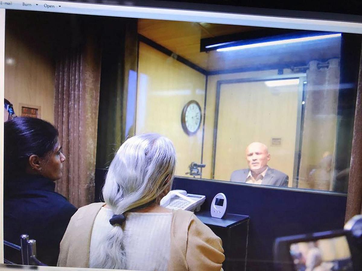 Former Indian Navy officer Kulbhushan Jadhav's wife and mother meet him while seated across a glass partition at the Pakistan Foreign Office in Islamabad. (PTI File Photo)