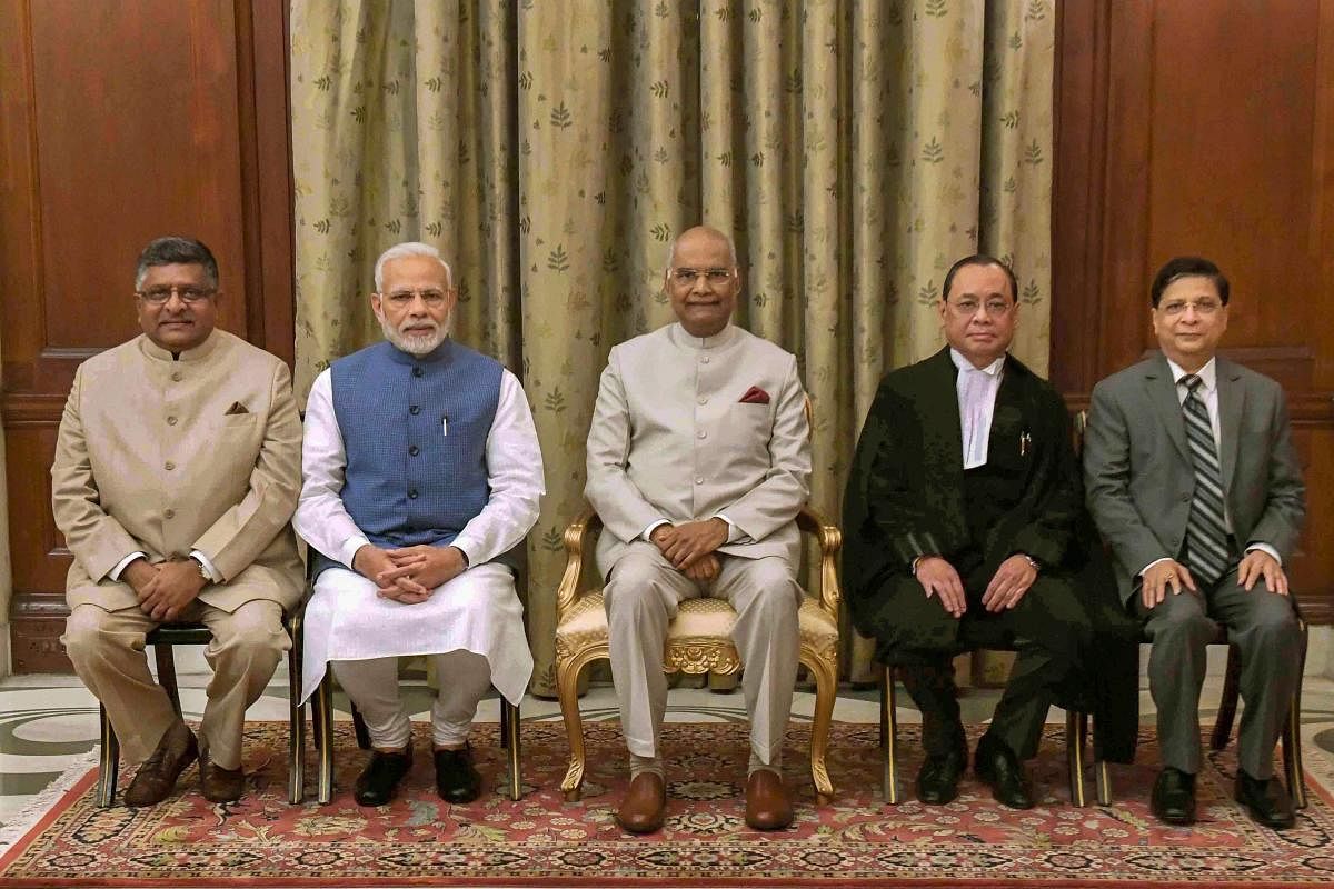 President Ram Nath Kovind flanked by newly sworn-in Chief Justice of India Justice Ranjan Gogoi (R) and Prime Minister Narendra Modi (L), after the oath taking ceremony, at Rashtrapati Bhawan, in New Delhi, Wednesday, Oct 3, 2018. Also seen are Union Law
