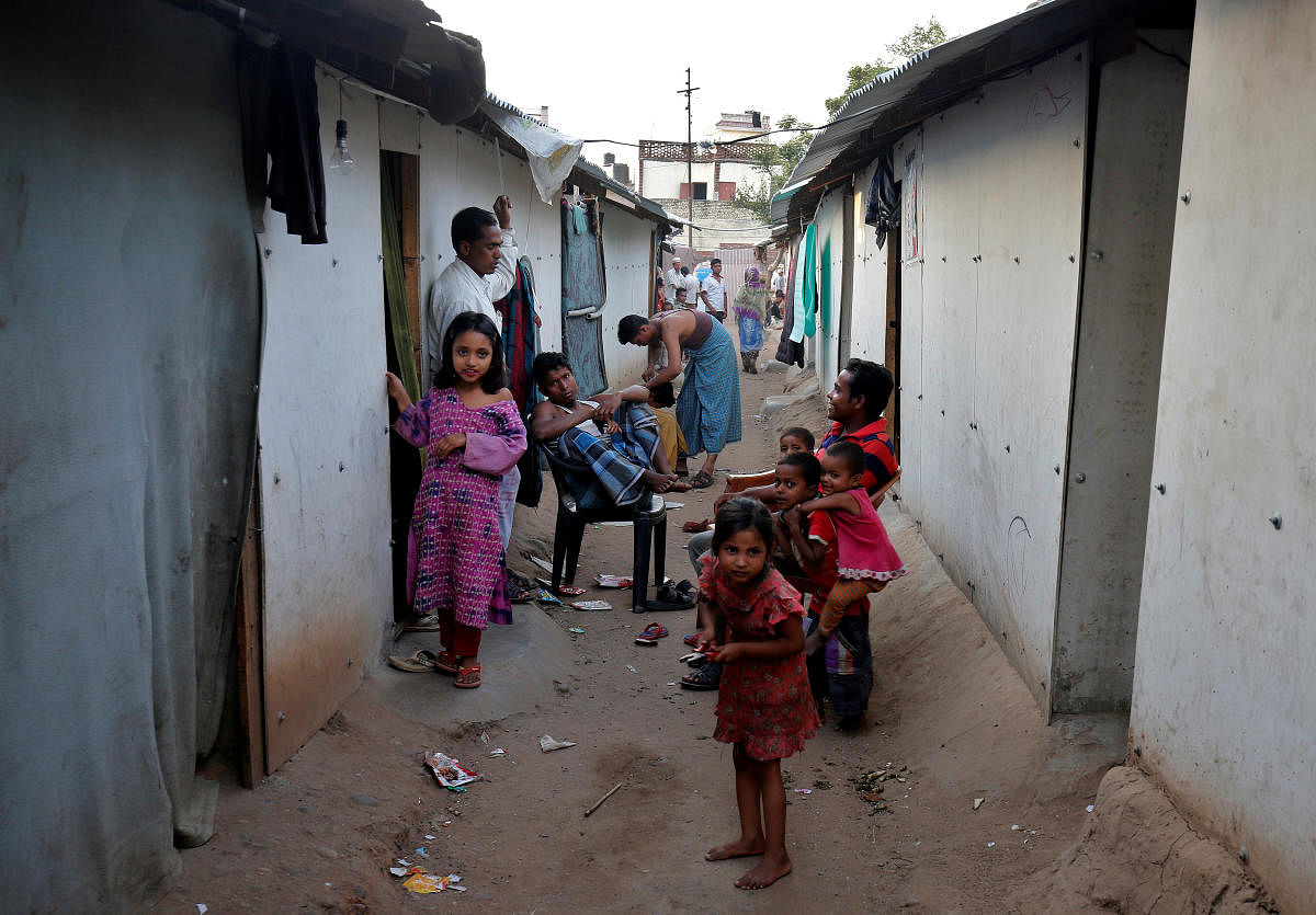 People belonging to Rohingya Muslim community sit outside their makeshift houses on the outskirts of Jammu. Picture taken on May 5, 2017. REUTERS/Mukesh Gupta/File Photo