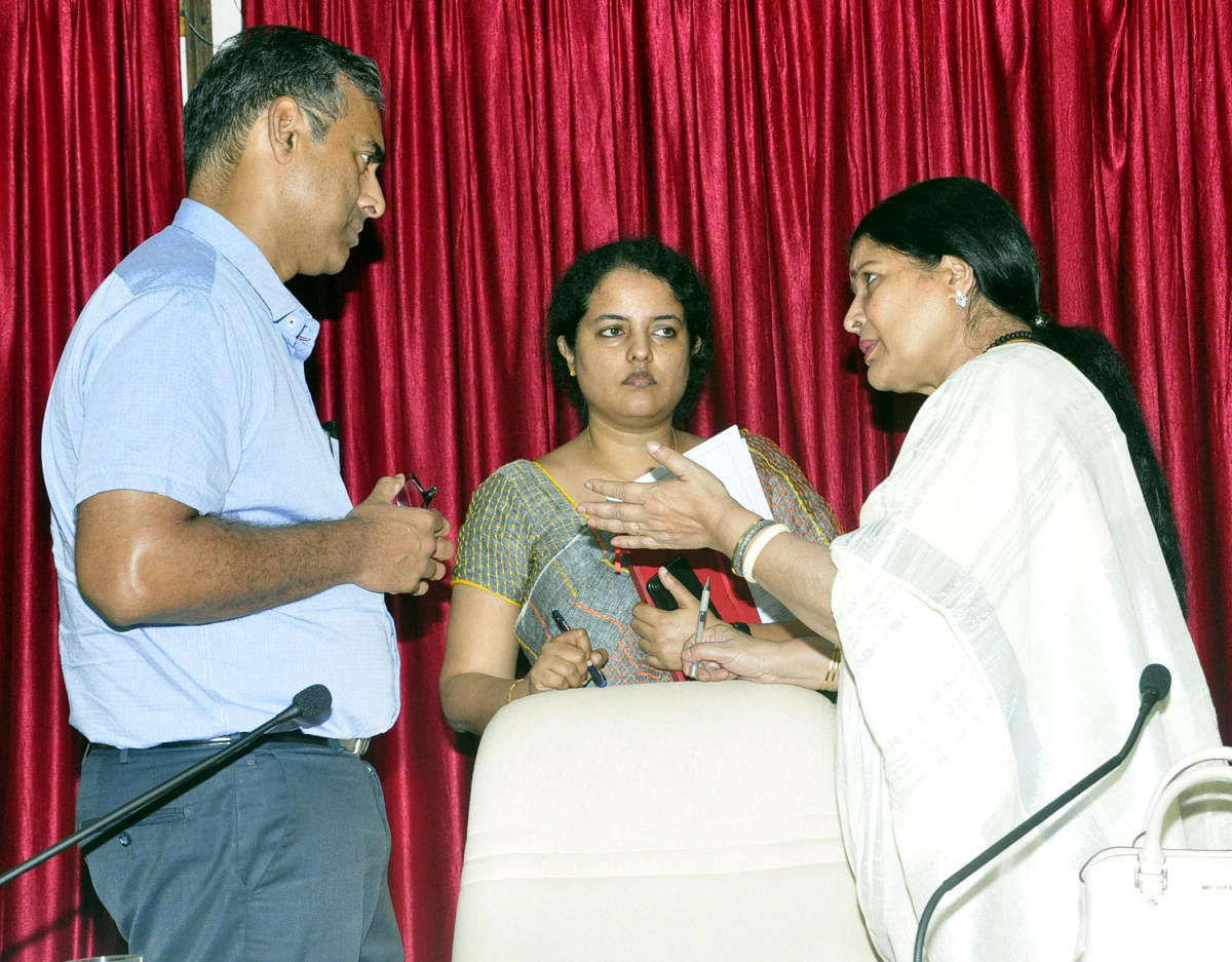 District In-charge Minister Jayamala (right) interacts with District In-charge Secretary Maheshwar Rao and Deputy Commissioner Priyanka Mary Francis after a KDP meeting in Udupi on Wednesday.