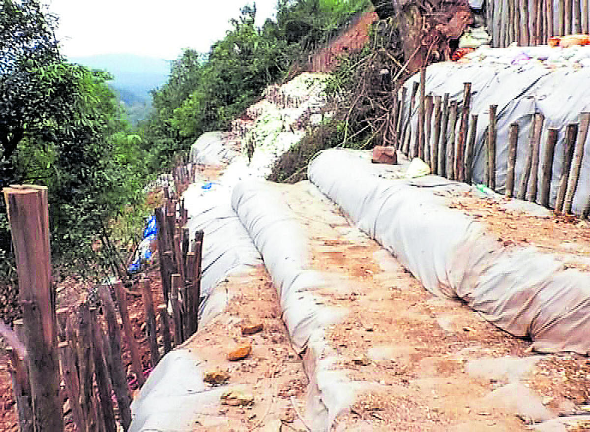 The road connecting the houses in block number 16 on Madikeri-Mangaluru National Highway 275 has been closed using sandbags.