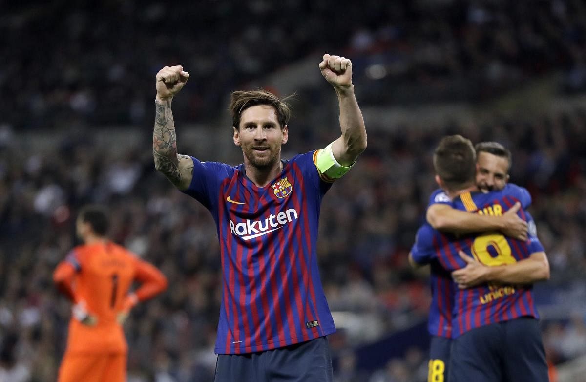 Barcelona forward Lionel Messi, center, celebrates after scoring his side's third goal during the Champions League Group B soccer match between Tottenham Hotspur and Barcelona at Wembley Stadium in London on Wednesday.(AP/PTI)