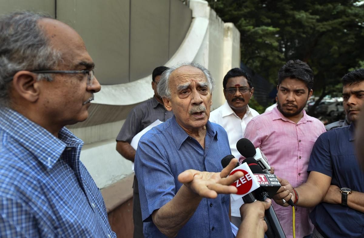 Former Union minister Arun Shourie addresses the media as Advocate Prashant Bhushan looks on, after meeting CBI Director Alok Verma in relation to Rafale Deal at CBI Headquarter in New Delhi. (PTI photo)