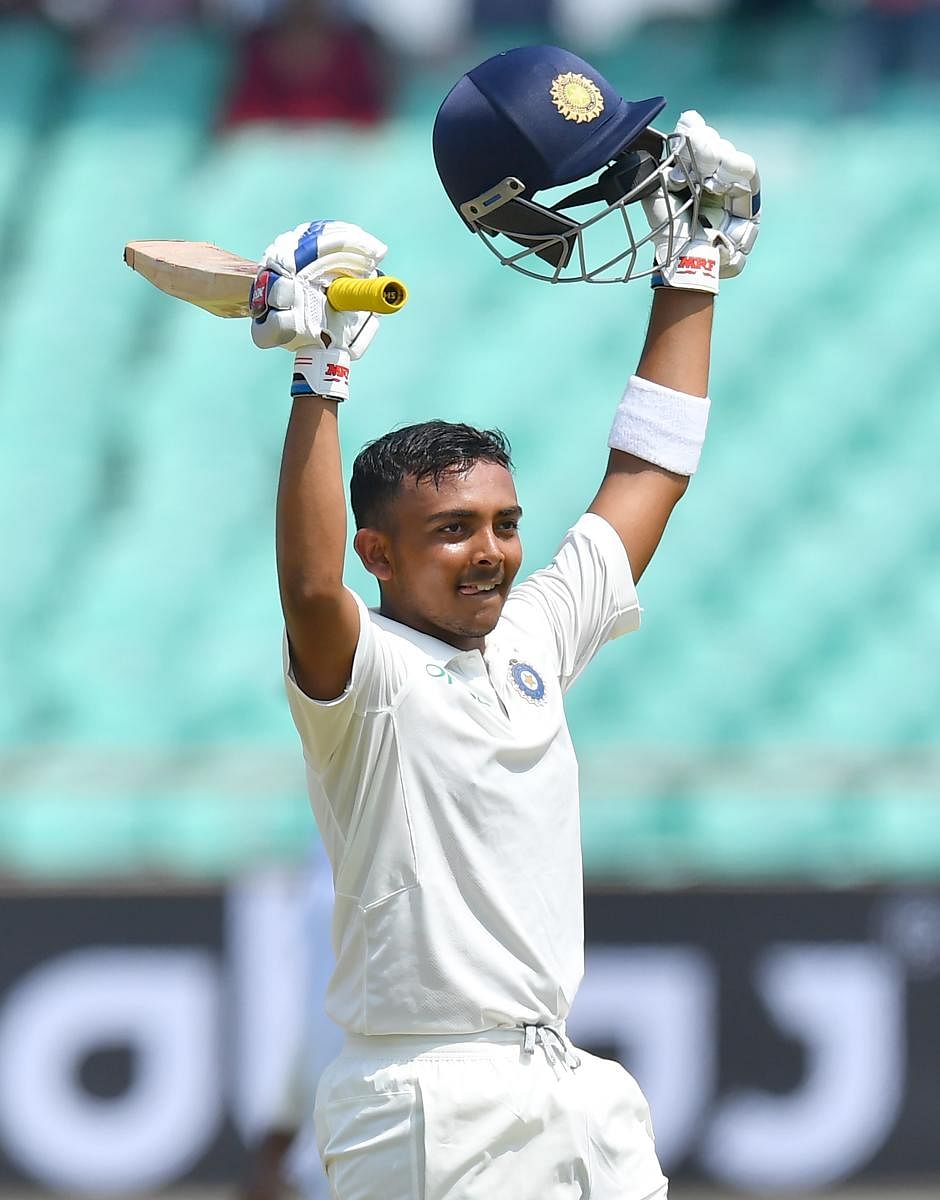 Prithvi Shaw celebrates after scoring a century in the first Test against West Indies at the Saurashtra Cricket Association stadium in Rajkot. AFP