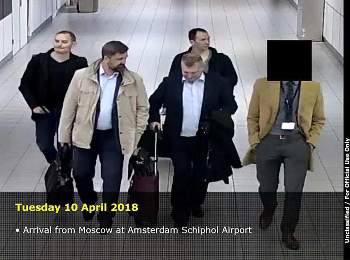 This handout document released on October 4, 2018 by the Dutch Defence Ministry shows four men arriving from Moscow at the Amsterdam Schiphol Airport on April 10, 2018. AFP