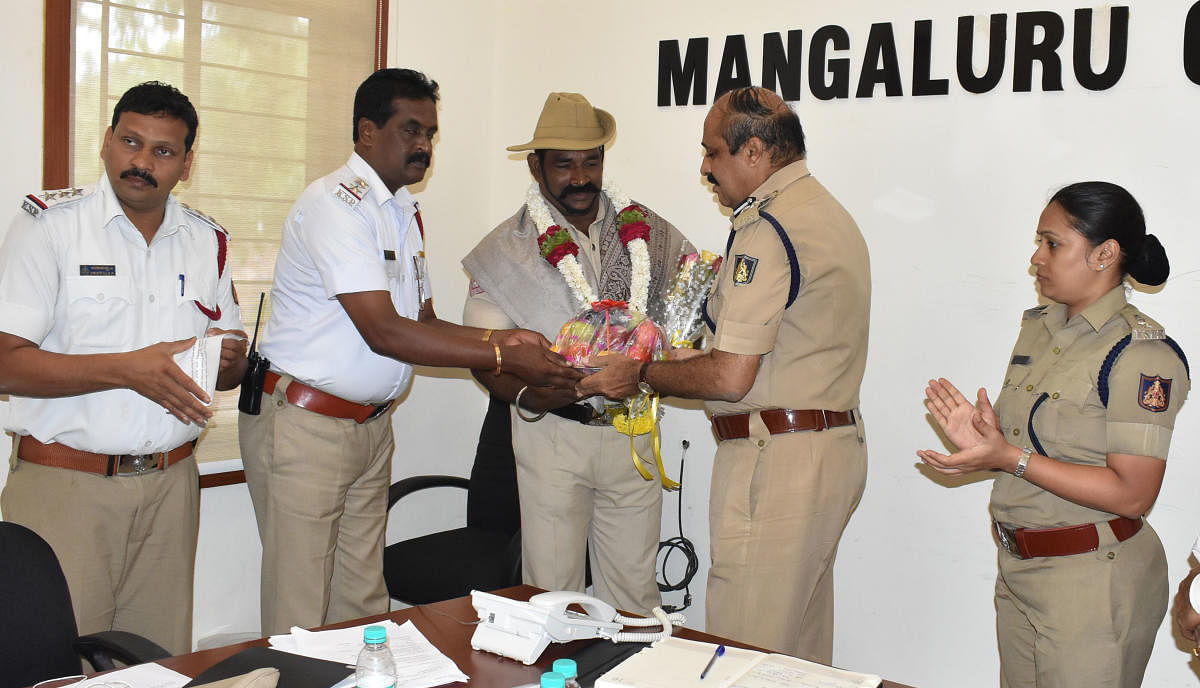 Moodbidri North subdivision head constable Vijay Kanchan being felicitated by City Police Commissioner T R Suresh for winning a silver medal in 105 kg category at the Asian Benchpress Championship held in Dubai recently.