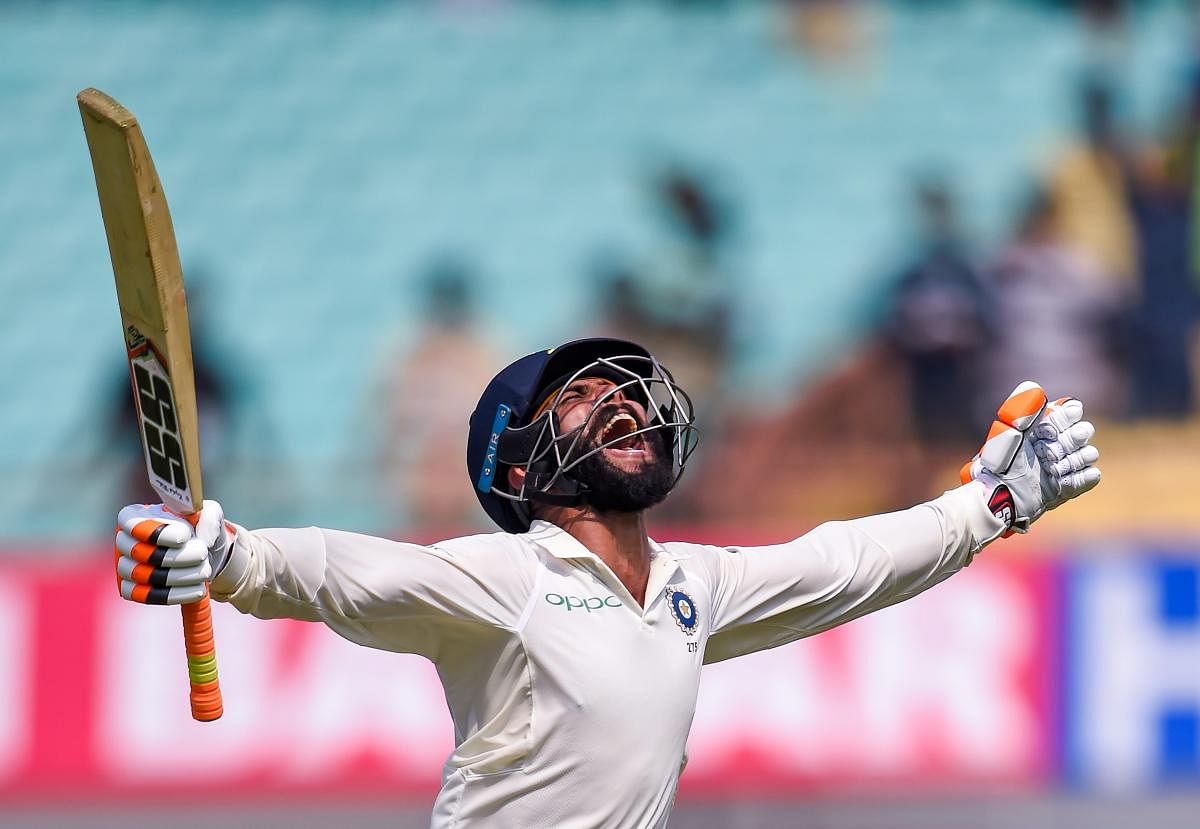 Ravindra Jadeja celebrates his century on the second day of the first Test against West Indies in Rajkot on Friday. PTI