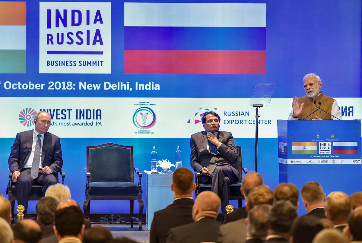 Prime Minister Narendra Modi addresses the India-Russia Business Summit as Russian president Vladimir Putin (L) and Union Commerce and Industry Minister Suresh Prabhu (C) look on, in New Delhi on Friday. PTI