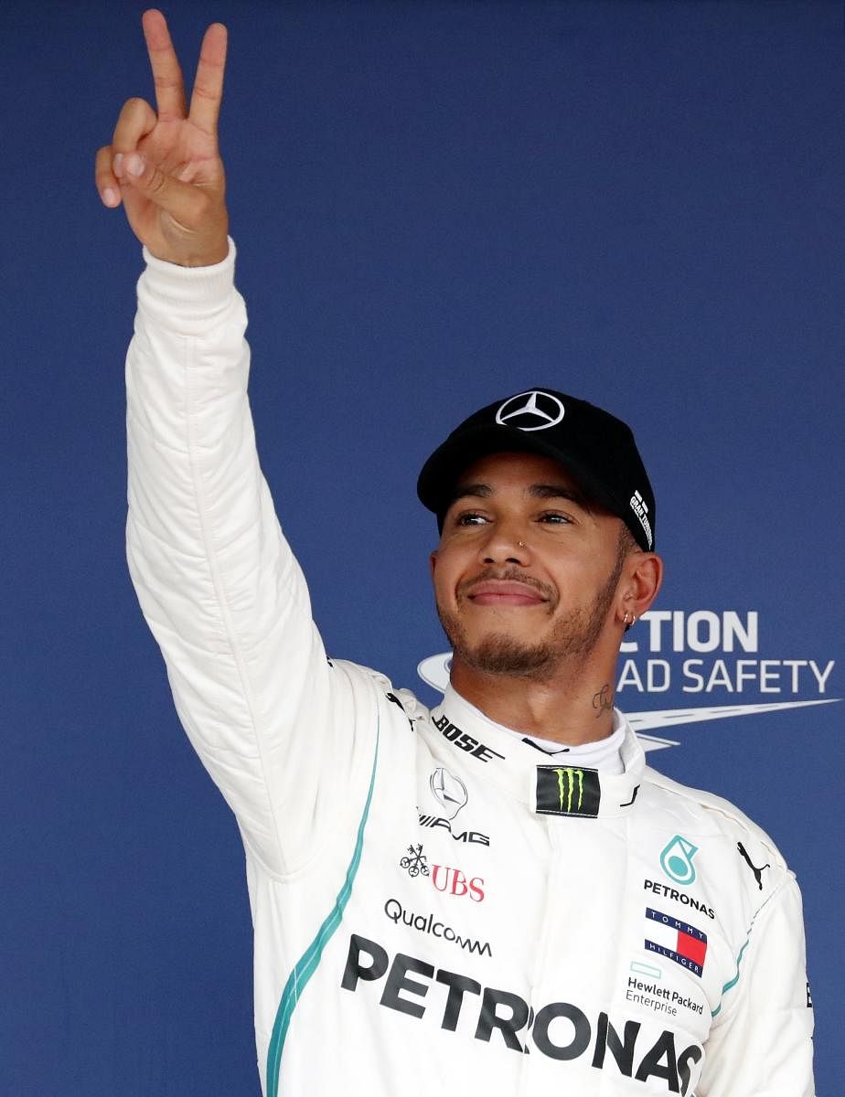 Mercedes' Lewis Hamilton celebrates after taking pole position for the Japanese Grand Prix on Saturday. REUTERS