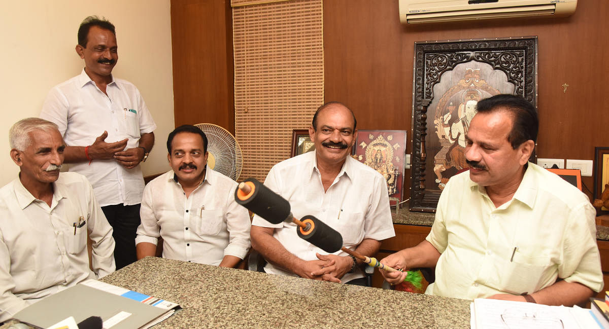 Union Minister D V Sadananda Gowda inspects an alternative whip, meant to be used in Kambala races, during a press meet in Mangaluru on Saturday.