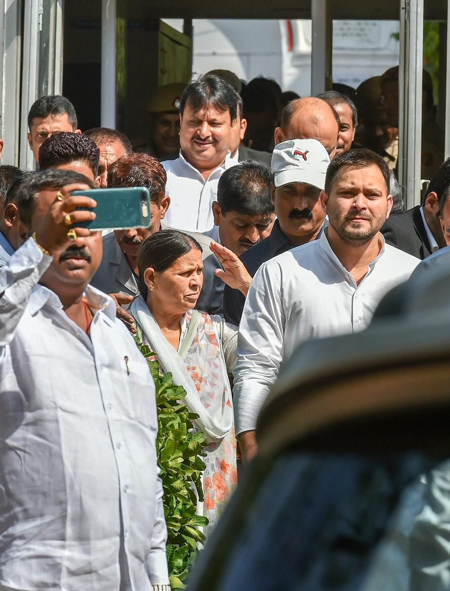 Former Bihar chief minister Rabri Devi with her son Tejashwi Prasad Yadav coming out from Patiala House court in (IRCTC) tender scam case, in New Delhi on Saturday. PTI