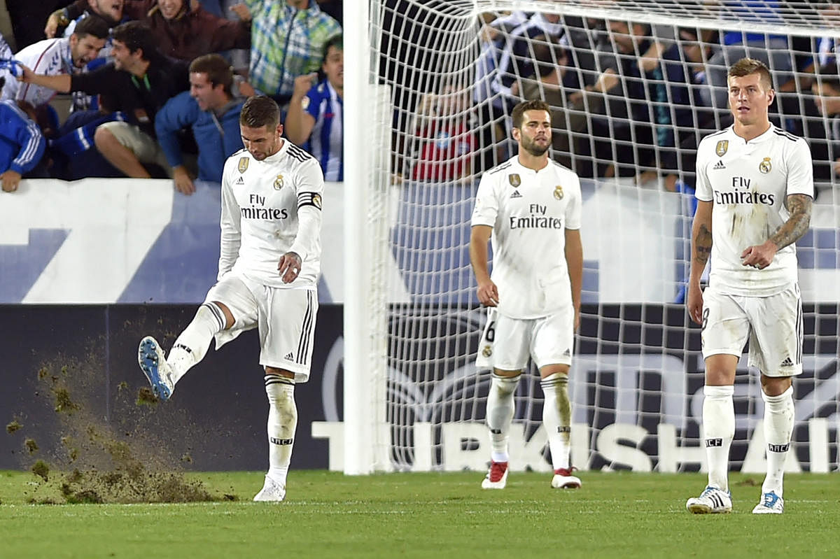 Real Madrid's (from left) captain Sergio Ramos, Nacho Fernandez and Toni Kroos wear a dejected look after suffering a shock defeat against Alaves on Saturday. AFP