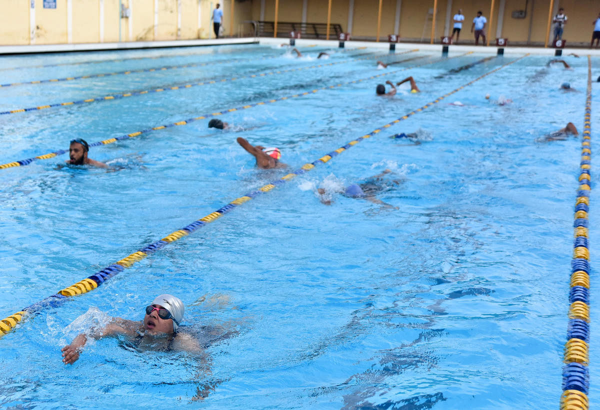 Triathletes in action during Dasara Triathlon at the University swimming pool in Mysuru on Sunday.