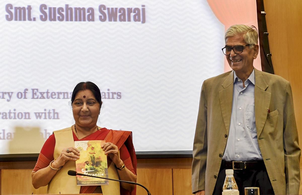 Union External Affairs Minister Sushma Swaraj releases a publication as Jaipur Foot Organisation founder DR Mehta looks on, at the launch of 'India For Humanity' initiative in New Delhi on Tuesday. PTI
