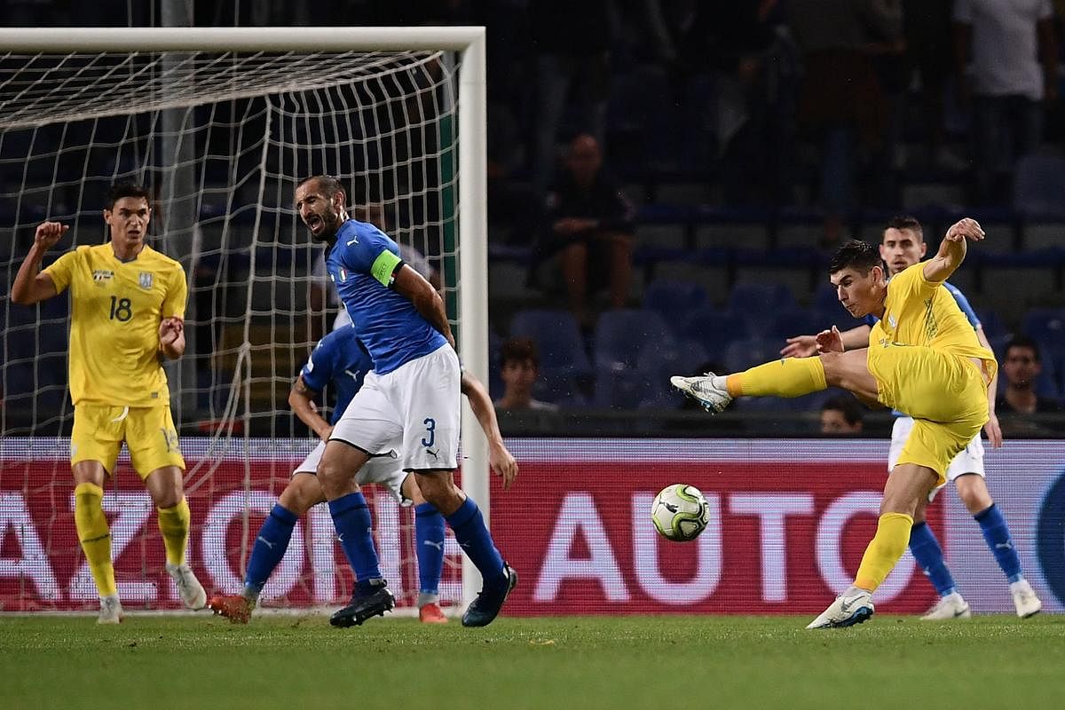 Ukraine's Ruslan Malinovskyi (right) shoots to score an equaliser during a friendly against Italy on Wednesday. AFP