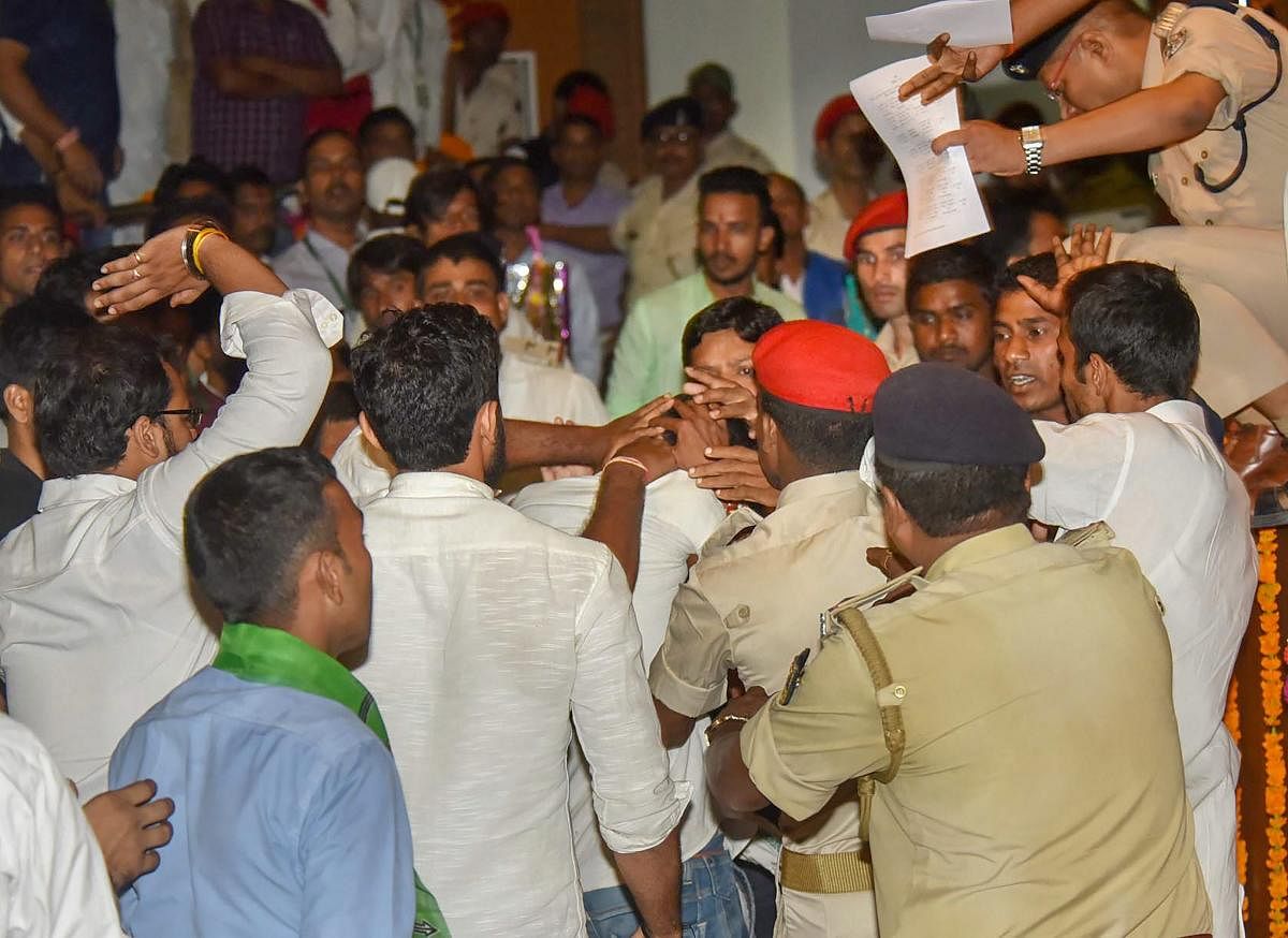 Police detain an unidentified man who threw a slippers at Bihar Chief Minister Nitish Kumar during 'Virat Chhatra Sanagam', in Patna, Thursday, Oct 11, 2018. (PTI Photo)