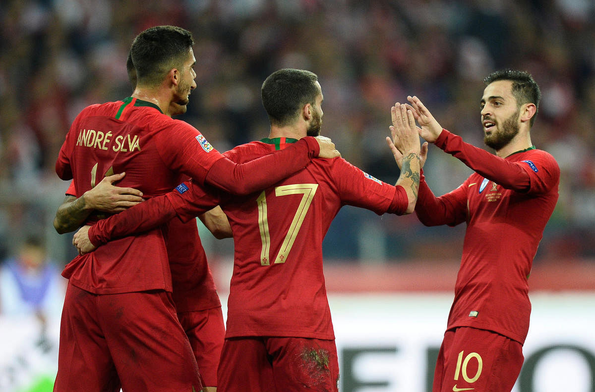 Portugal's Bernardo Silva (right) celebrates with team-mates after scoring against Poland. REUTERS