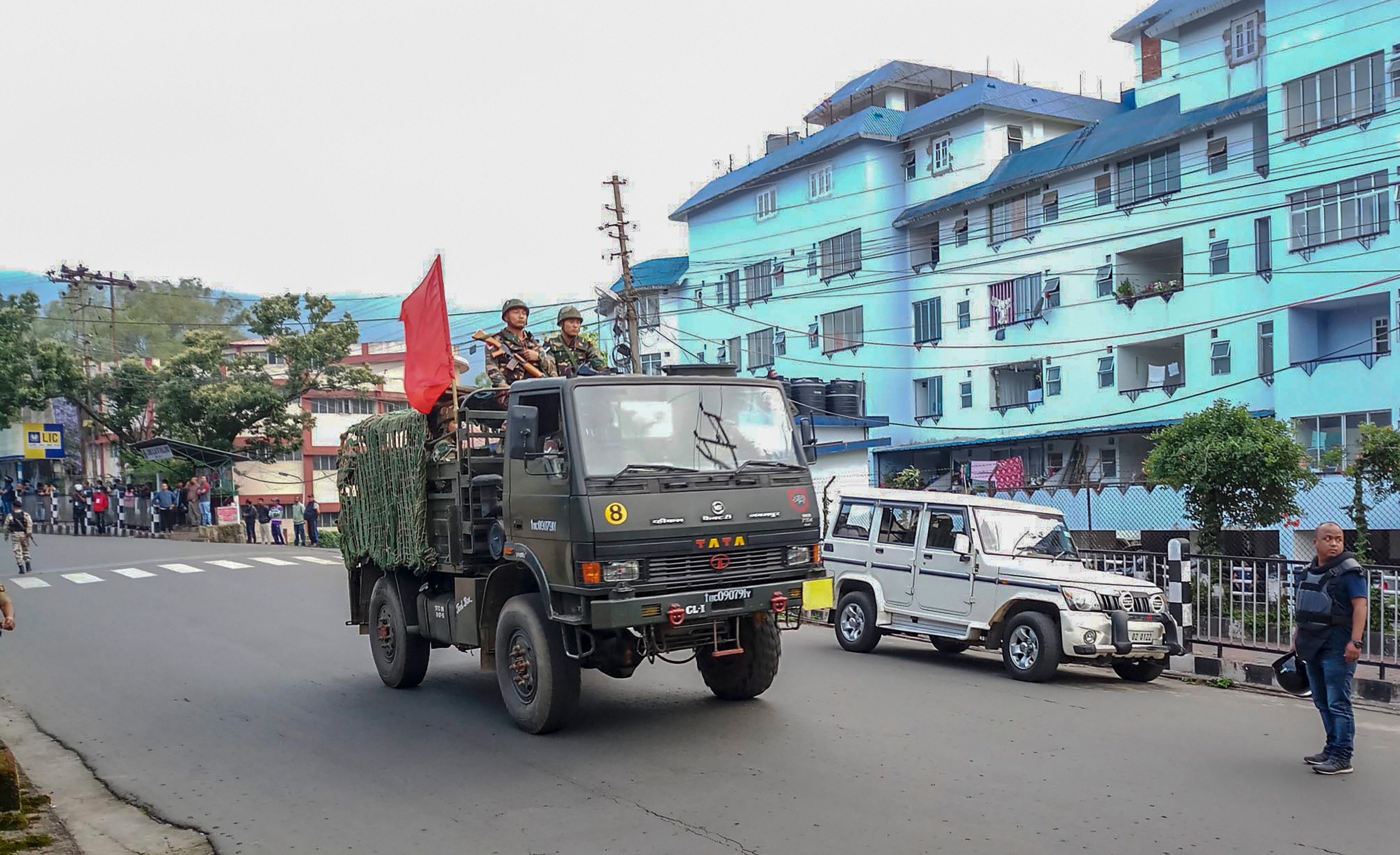 Army personnel patrol a street during curfew after clashes between the residents of the city's Punjabi Line area and Khasi drivers of state-run buses, in Shillong on Monday. PTI