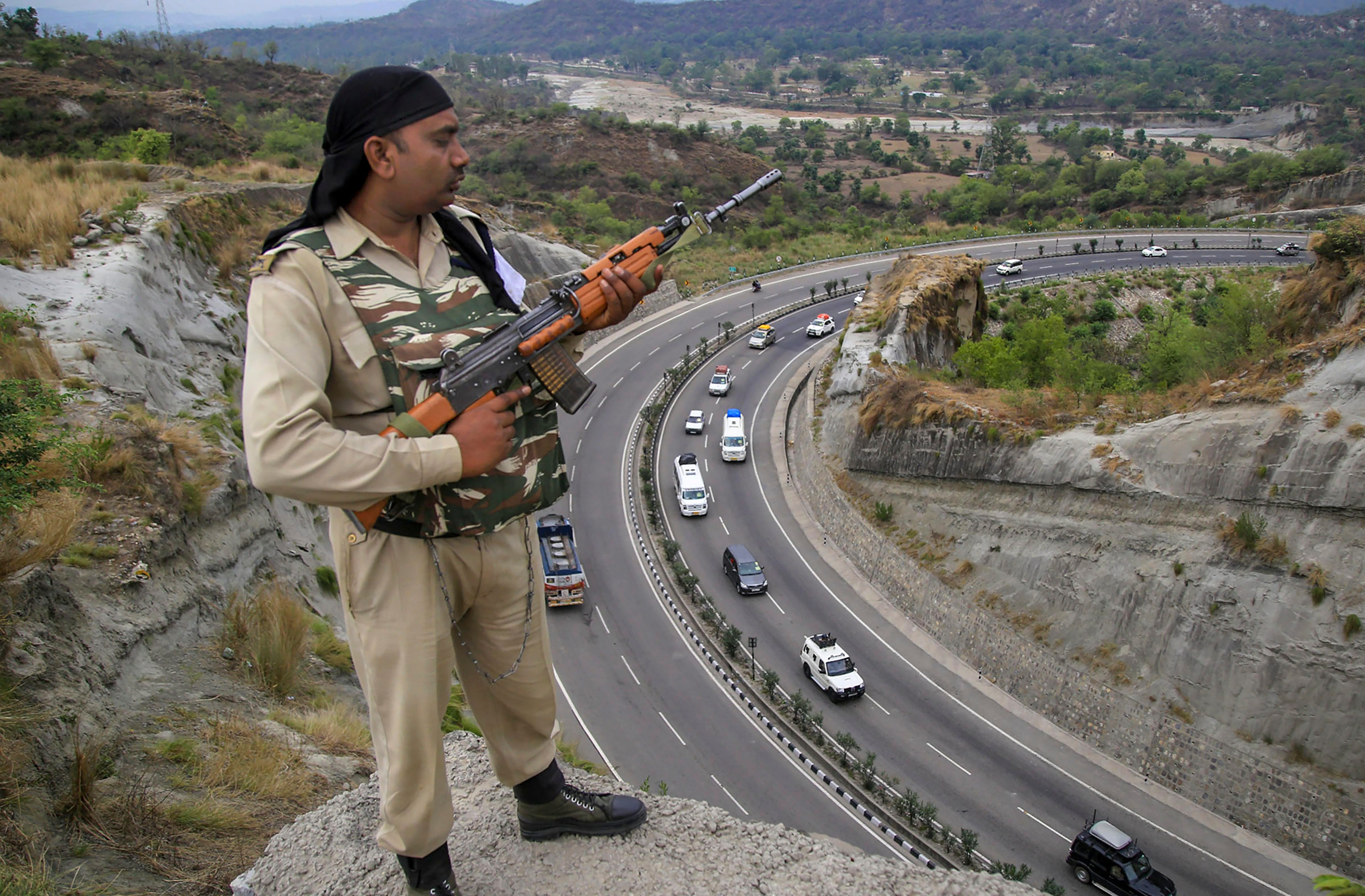 A paramilitary soldier stands guard as the first batch of pilgrims leave for Amarnath Yatra, in Jammu on Wednesday. (PTI Photo) 