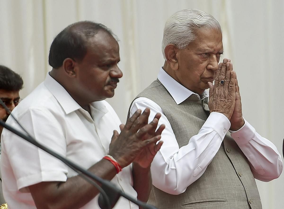 Karnataka Governor Vajubhai Vala and Chief Minister H D Kumaraswamy during the swearing-in ceremony of newly inducted ministers during the first expansion of the JD(S) and Congress coalition government, at Rajbhavan in Bengaluru on Wednesday, June 06, 201