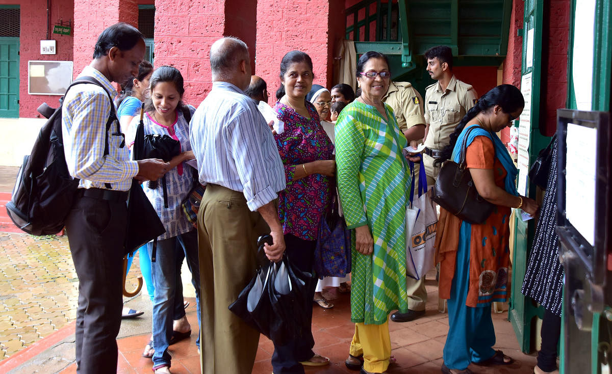 Voters standing in a queue to exercise their franchise, at one of the polling booths, at University College, in Hampankatta on Friday.
