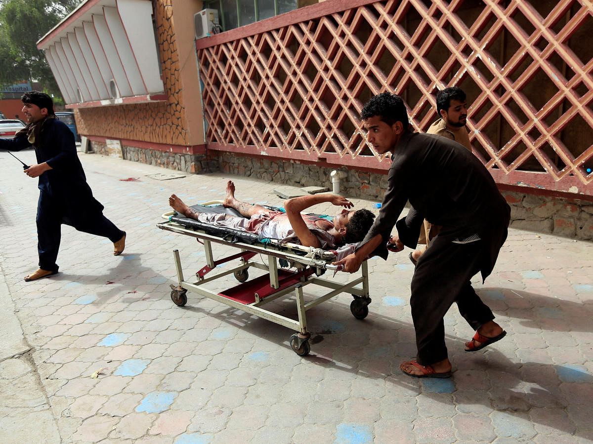 An injured man is pushed on a stretcher to a hospital after a car bomb in Jalalabad city, Afghanistan. (Reuters Photo)