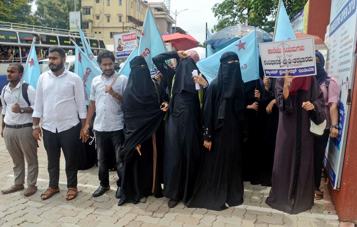Students, under the aegis of Campus Front of India, stage a protest demanding to allow headscarf inside the classrooms, in front of St Agnes College in Mangaluru on Monday.