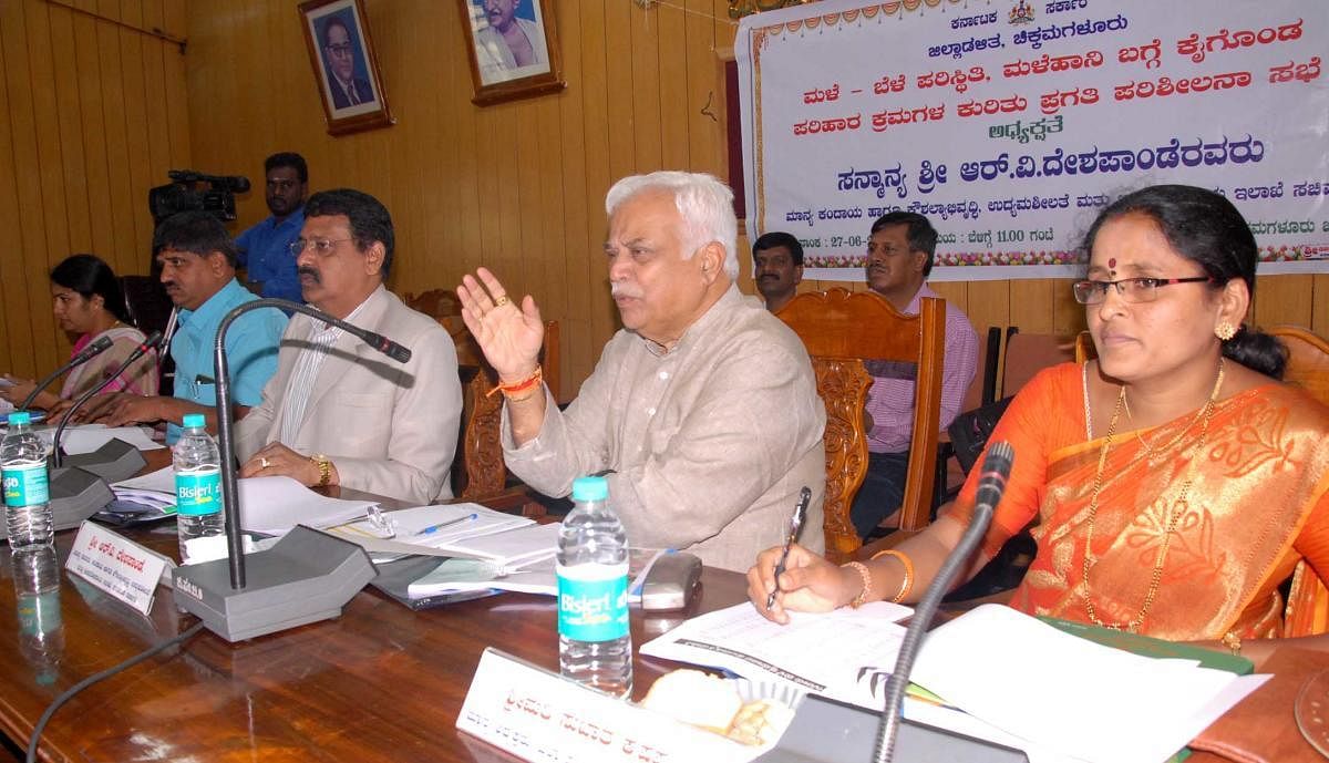 Revenue Minister R V Deshpande chairs a review meet on the rain relief works, at Zilla Panchayat auditorium in Chikkamagaluru on Wednesday. Deputy Commissioner M K Srirangaiah and Zilla Panchayat CEO Satyabhama look on. DH PHOTO