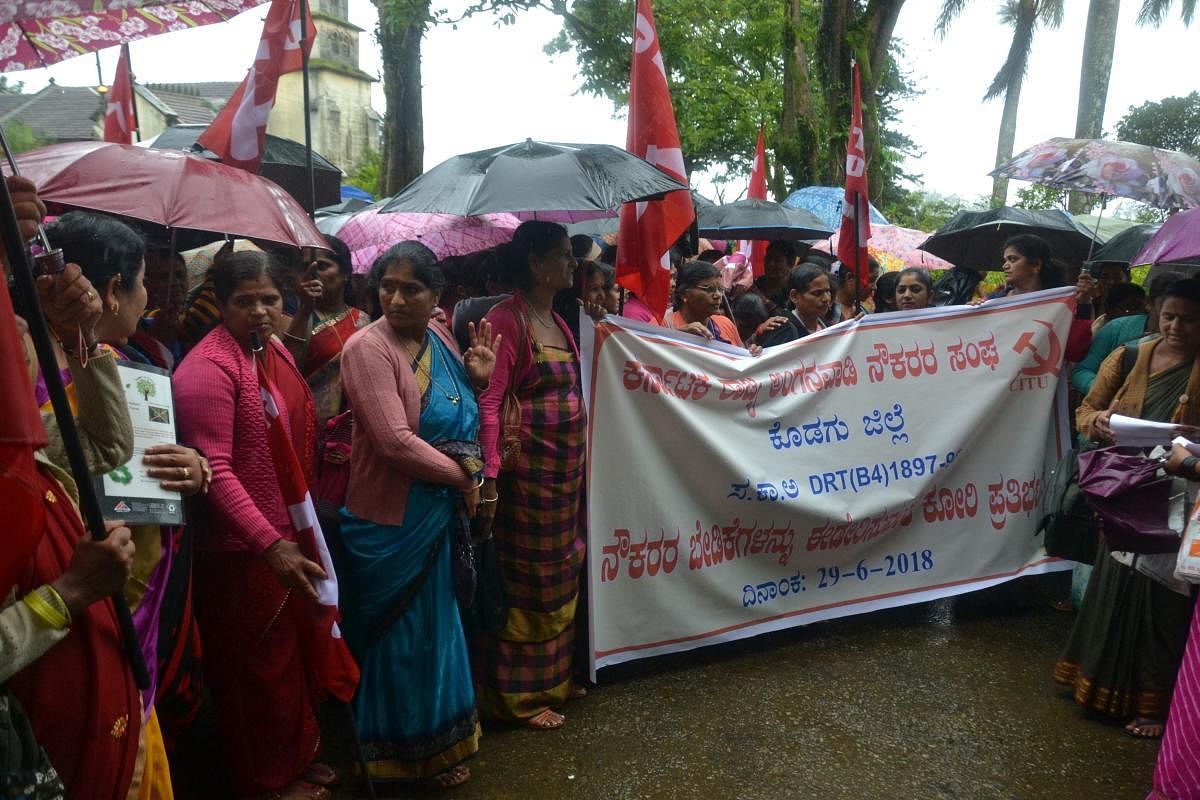 Anganwadi workers stage a protest in Madikeri on Friday.