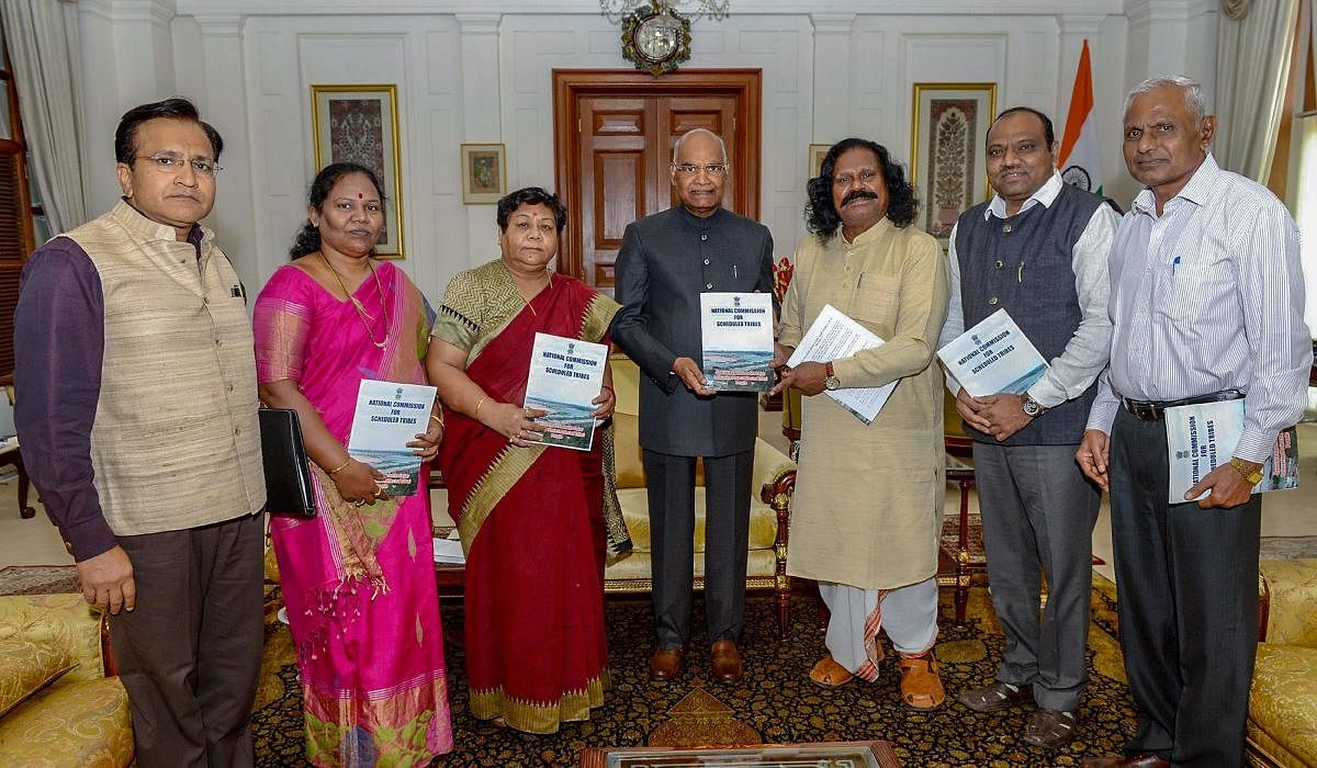President Ram Nath Kovind receives a special report of the Commission on 'Indira Sagar Polavaram Project Affected Tribal People' from National Commission for Scheduled Tribes Chairperson Dr Nand Kumar Sai at Rashtrapati Bhavan, in New Delhi on Tuesday. PT
