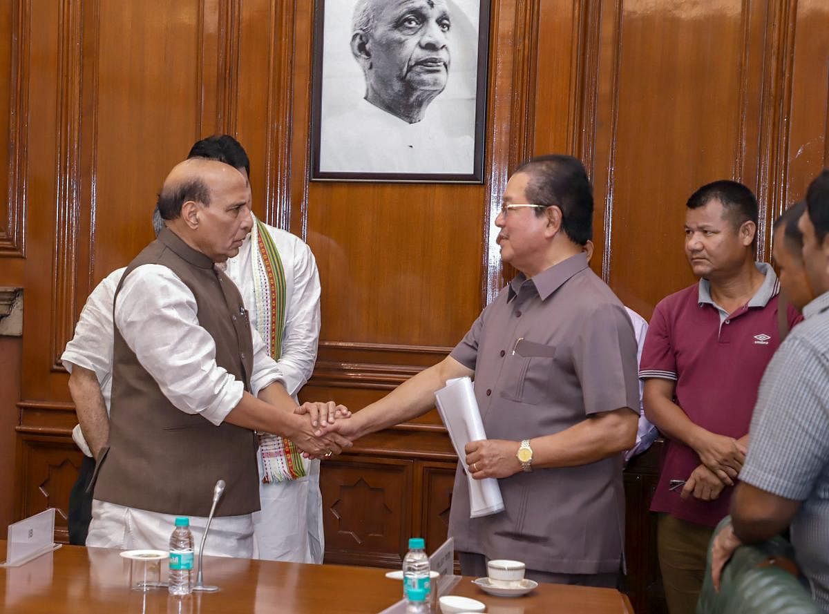 Union Home Minister Rajnath Singh shakes hands with Mizoram Chief Minister Pu Lalthanhawla after the signing of an agreement on repatriation of Bru tribe members to Mizoram, in New Delhi on Tuesday. PTI