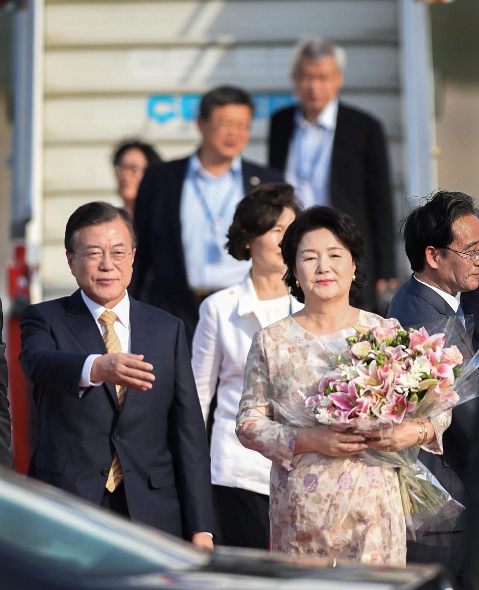 South Korean President Moon Jae-in with First Lady Kim Jung-sook arrive at Air Force Station (AFS) Palam, in New Delhi on Sunday. PTI
