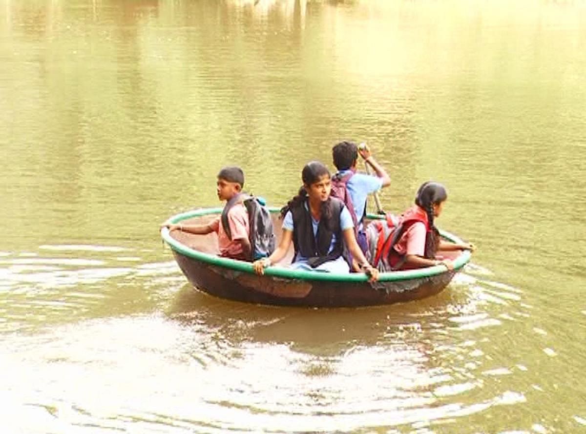 Children cross the Bhadra river to reach their school in Holekoodige.