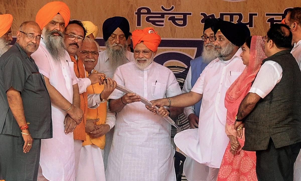 Prime Minister Narendra Modi being presented a 'kirpan', or sword, during the Kisan Kalyan Rally (farmers' rally) in Malout, Punjab on Wednesday. (PTI Photo)