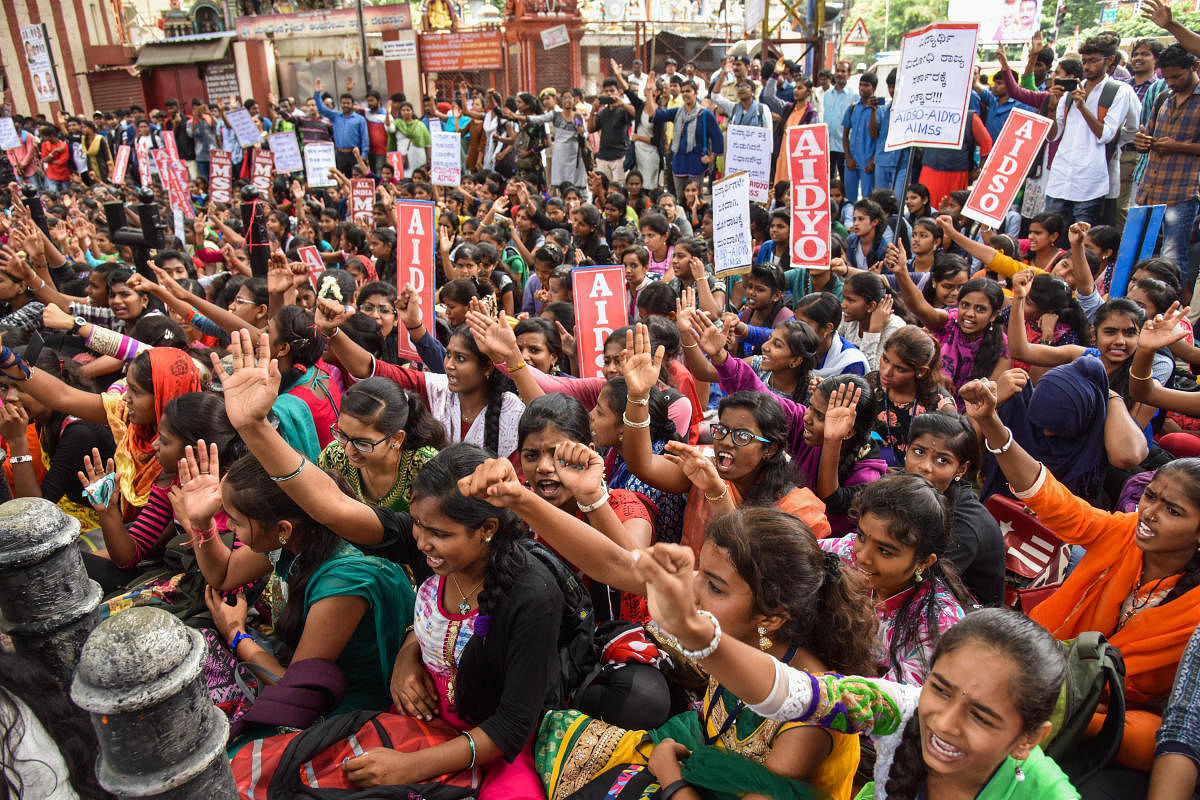 Students are staging protest, against state government, demanding student free bus pass under the banner of AIDSO, AIDYO and AIMSS, at Mysore Bank Circle in Bengaluru on Wednesday. Photo by S K Dinesh