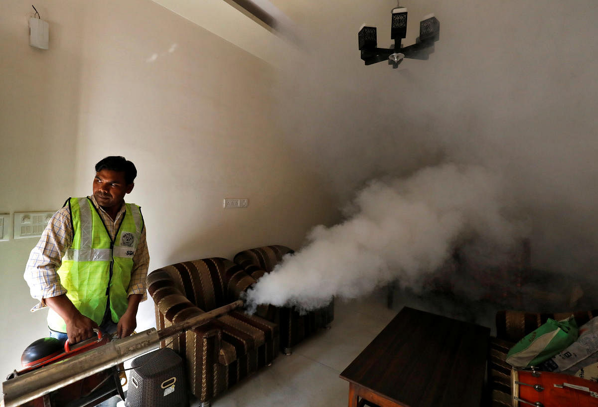 A public health department worker fumigates inside a house to prevent the spread of mosquito borne diseases in New Delhi, India, October 9, 2018. (REUTERS)