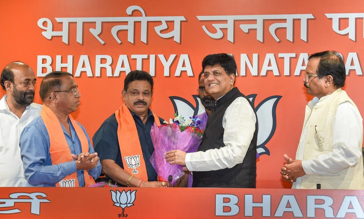 Subhash Shirodkar and Dayanand Sopte being felicitated by Railway Minister Piyush Goyal upon joining the BJP in New Delhi on Tuesday. PTI