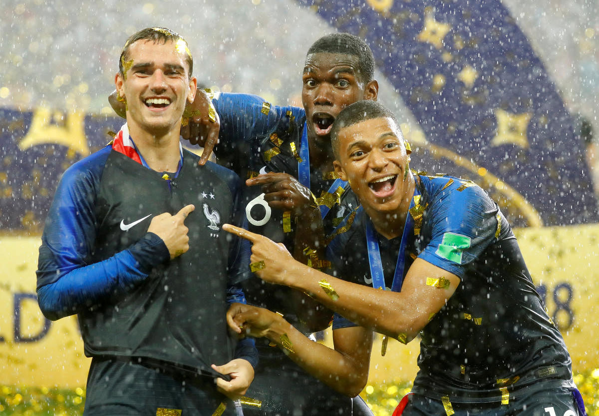 France's Antoine Griezmann, Paul Pogba and Kylian Mbappe celebrate after winning the World Cup. REUTERS
