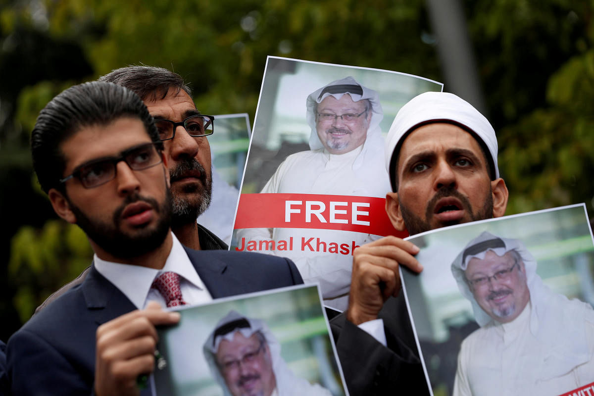 Human rights activists and friends of Saudi journalist Jamal Khashoggi hold his pictures during a protest outside the Saudi Consulate in Istanbul, Turkey October 8, 2018. (REUTERS/Murad Sezer/File Photo)