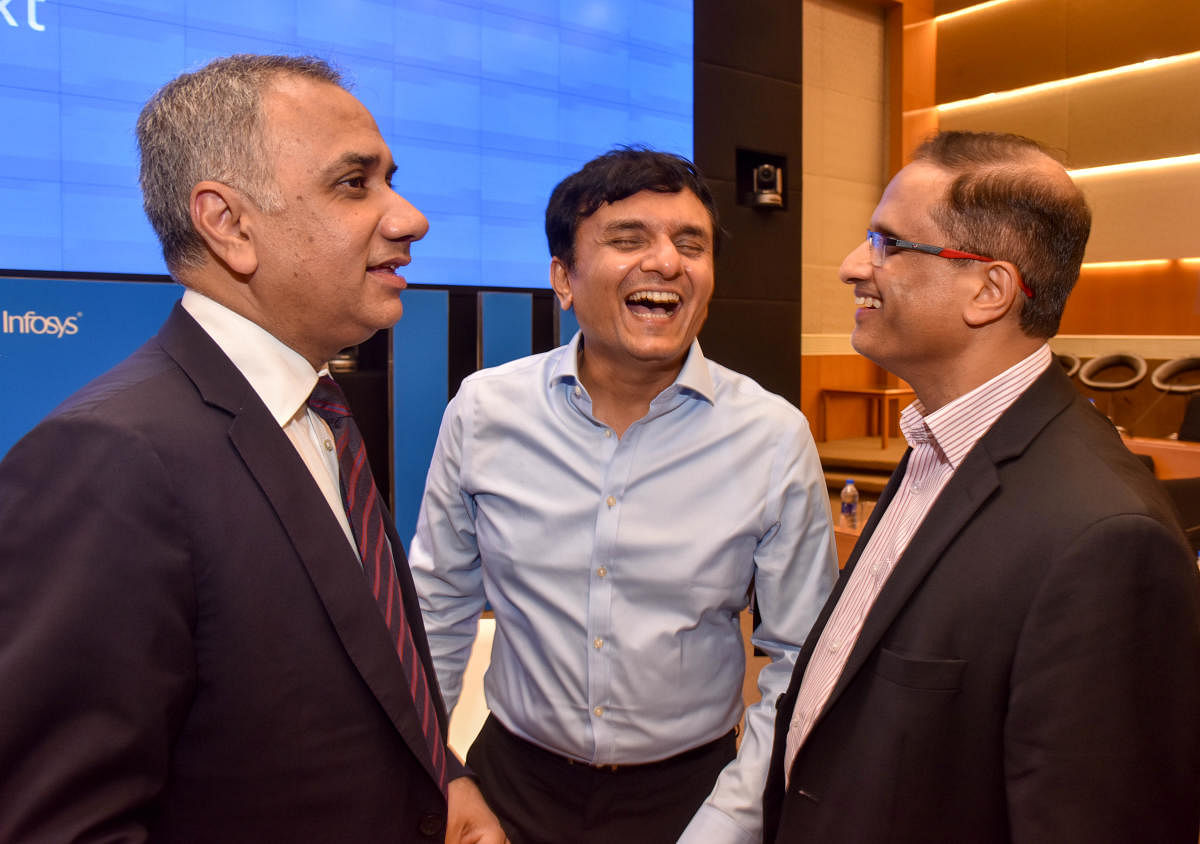 (From Left) Infosys CEO Salil Parekh, CFO Ranganath and COO U B Pravin Rao are interacting during the quarterly results at Infosys campus, in Bengaluru on Tuesday. DH Photo: B H Shivakumar