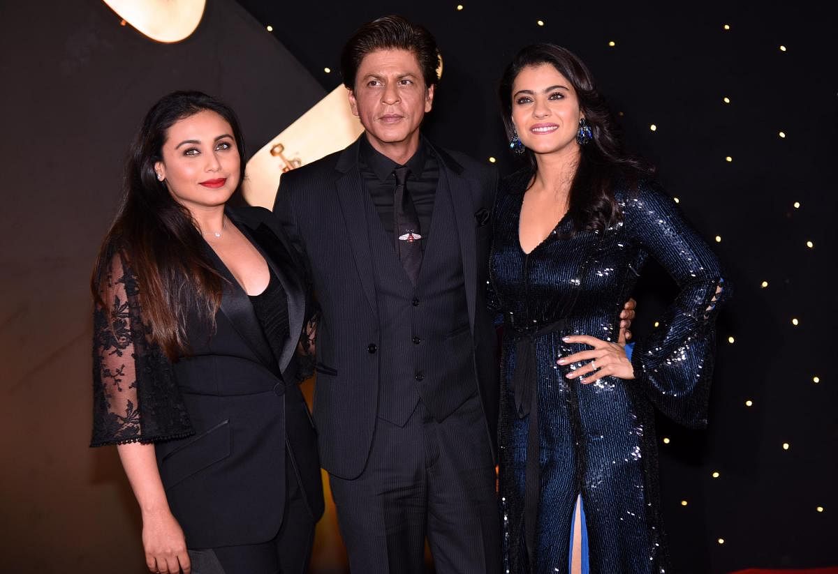 Indian Bollywood actors Rani Mukharjee, Shah Rukh Khan and Kajol Devgan pose for a picture as they attend an event celebrating the 20th anniversary of the Hindi film "Kuch Kuch Hota Hai", in Mumbai on October 16, 2018. (AFP File Photo)