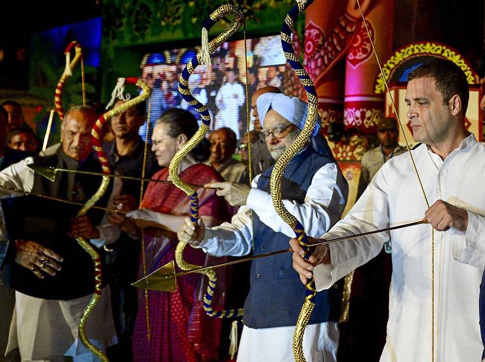 Congress President Rahul Gandhi with former prime minister Manmohan Singh and UPA chairperson Sonia Gandhi release arrows from bow for the burning of evil king Ravana during Dussehra celebrations of Nav Shri Dharmik Leela Committee at Red Fort in New Delhi. PTI Photo