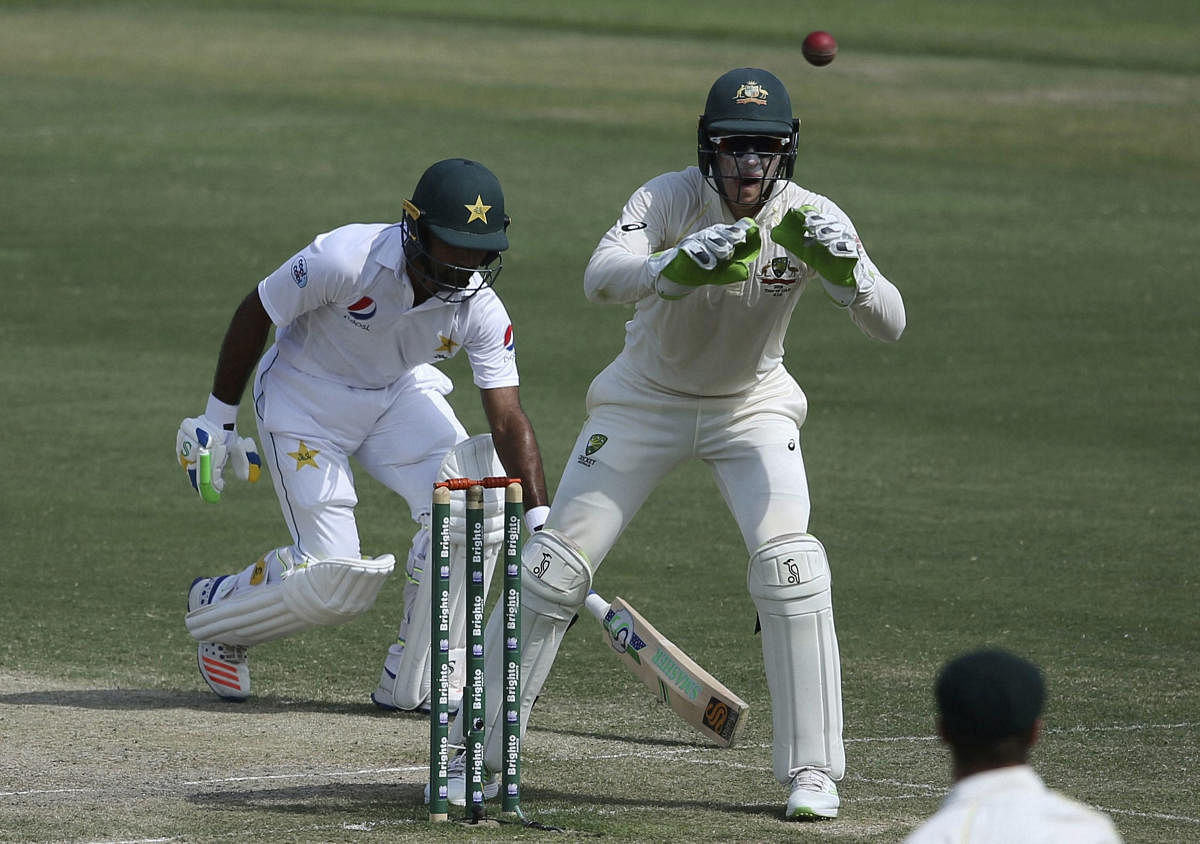 Abu Dhabi: Australia's Tim Paine, right, tries to catch the ball as Pakistan's Asad Shafiq saves the wicket during their cricket test match in Abu Dhabi, United Arab Emirates, Thursday, Oct. 18, 2018. AP/PTI(AP10_18_2018_000038B)