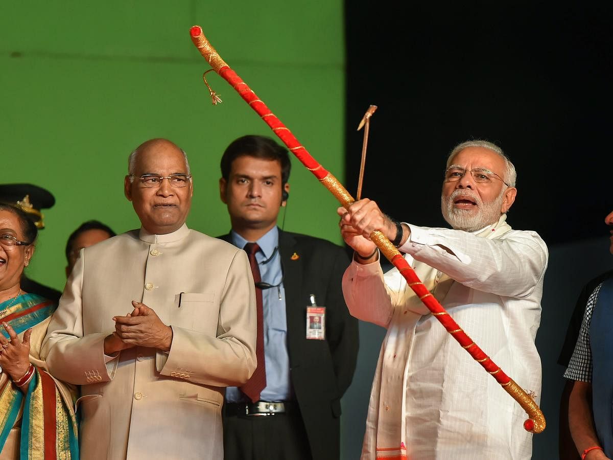 Prime Minister Narendra Modi releases the arrow with a bow to symbolically set on fire the effigy of evil king Ravana during Dussehra celebrations of Luv Kush Ramleela Committee at Red Fort ground in New Delhi, Friday on Friday. PTI photo