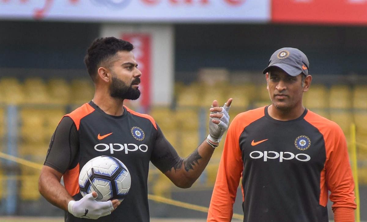 Indian captain Virat Kohli (left) with M S Dhoni on the eve of the first ODI against the West Indies in Guwahati on Saturday. PTI