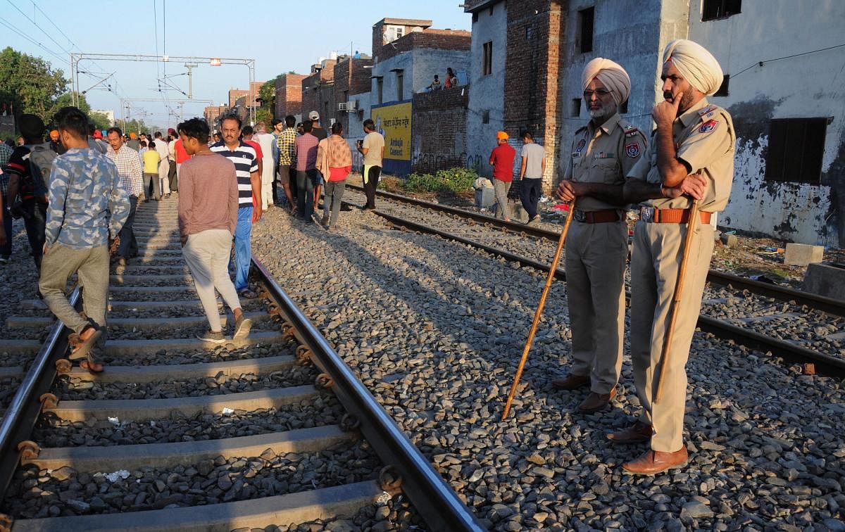 Punjab Police personnel at the scene of the accident along railroad tracks in Amritsar. PTI photo