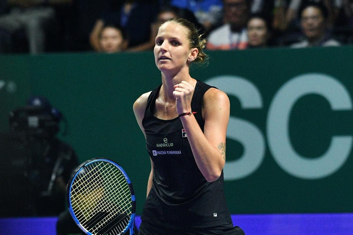 Czech Republic's Karolina Pliskova celebrates after defeating Denmark's Caroline Wozniacki during their women's singles match at the WTA Finals. AFP