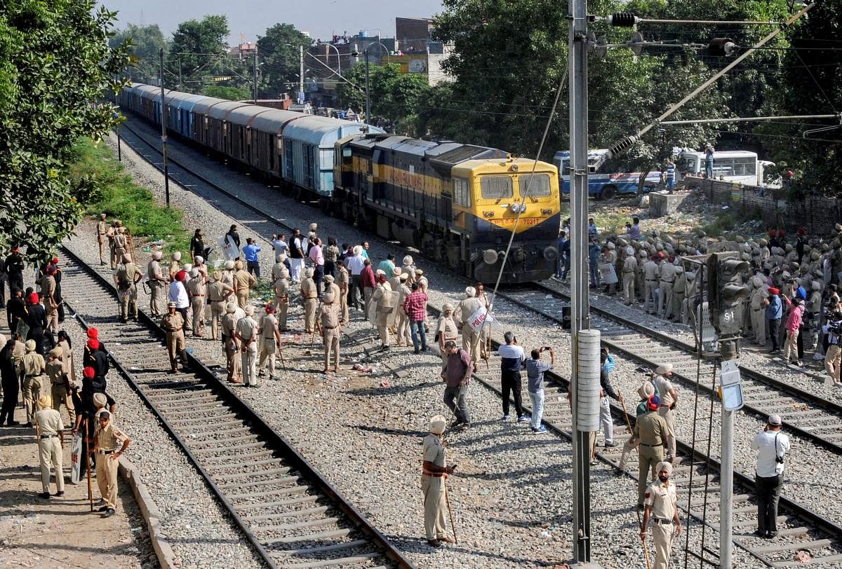  Security on high alert as the first train passes by before the resumption of railway services since the train accident in Amritsar on Sunday. PTI photo