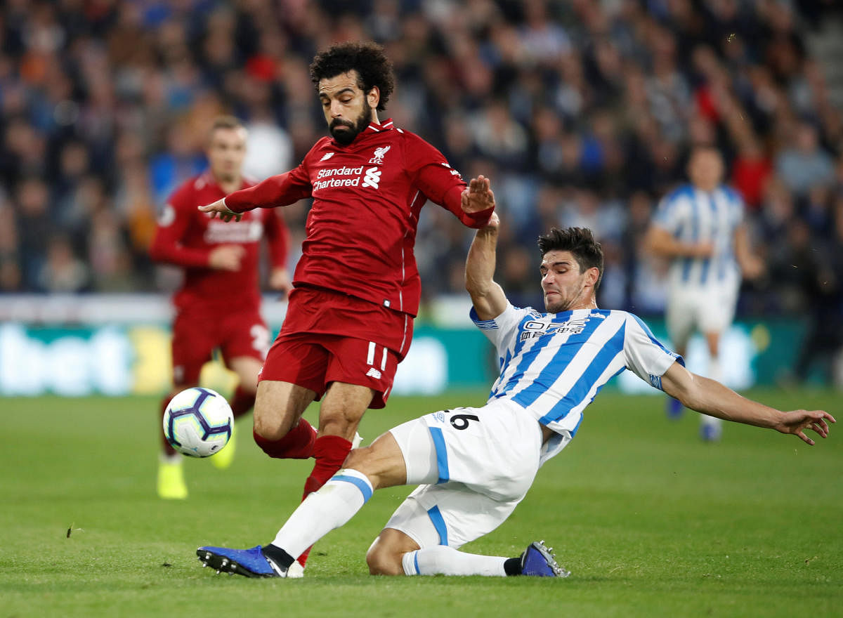 Huddersfield Town's Christopher Schindler attempts to tackle Liverpool's Mohamed Salah. Reuters 